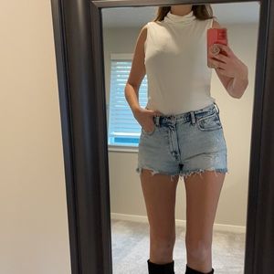 White sleeveless turtleneck